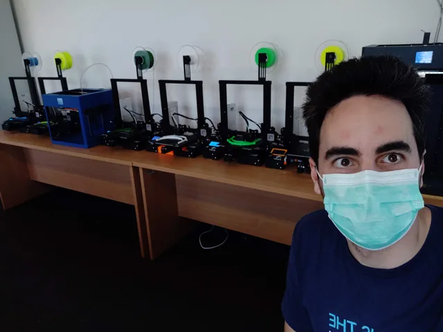 A row of 3D printers running face shield parts during covid