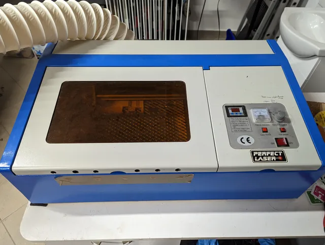 K40 laser cutter and engraver with its exhaust hose attached